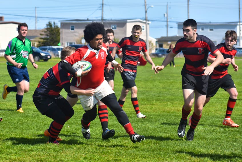 Braidan Sullivan, centre, of the Riverview Rugrats, gets tackled by a player from the Glace Bay Panthers during Nova Scotia School Athletic Federation Division 2 rugby provincial championships at Hub Field in Glace Bay on Friday. Glace Bay won the game 38-5.