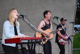 Port Cities, from left, Breagh MacKinnon, Carleton Stone and Dylan Guthro perform at the finale of the Makin’ Waves concert series on Thursday at Wentworth Park in Sydney. About 1,500 people took in the concert that remained outdoors despite the heat and a risk of a thunderstorm.