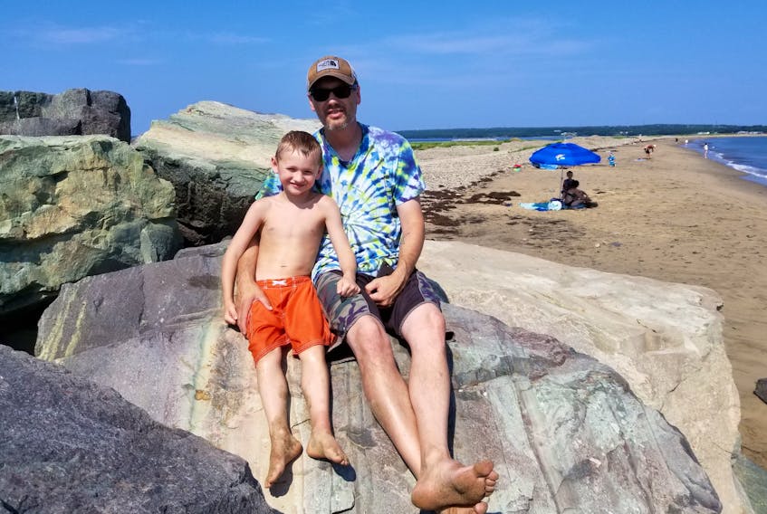 Felix Wylde, 5, and his father Chris Wylde from Point Clark, Ont., took time from their vacation visiting in-laws on Cape Breton Island to take a trip to the Dominion Beach on Thursday morning, in an effort to beat the heat.