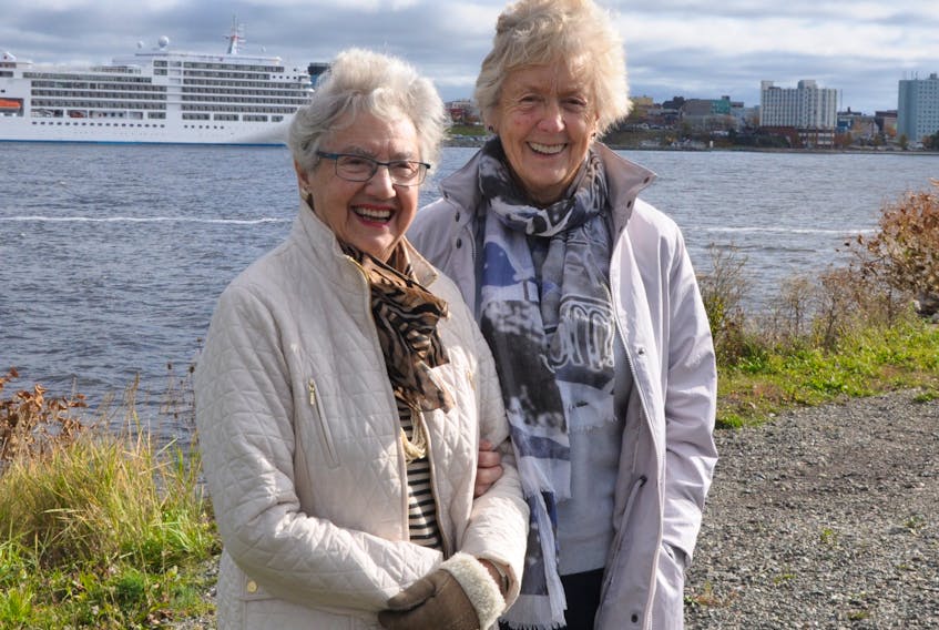 Ninety-one-year-old Jean Knight, left and traveling companion Cynthia Skae, 83, were all smiles after getting an unexpected tour of the Sydney area after arriving in Cape Breton aboard the Silver Spirit cruise ship that is visible in the background. The veteran world travelers said they loved their short visit to the area with one amazed by the number of wooden houses and the other struck by the amount of undeveloped and wide-open spaces.