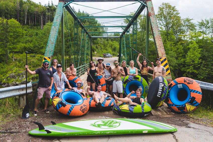 A group of friends and fellow outdoor enthusiasts pose for a photo in Margaree Forks in August during adventure tourism company, Live Life InTents, weekend of summer games that included an afternoon of tubing down the Margaree River, which was held to promote the business built by brothers Lee and Liam Fraser.