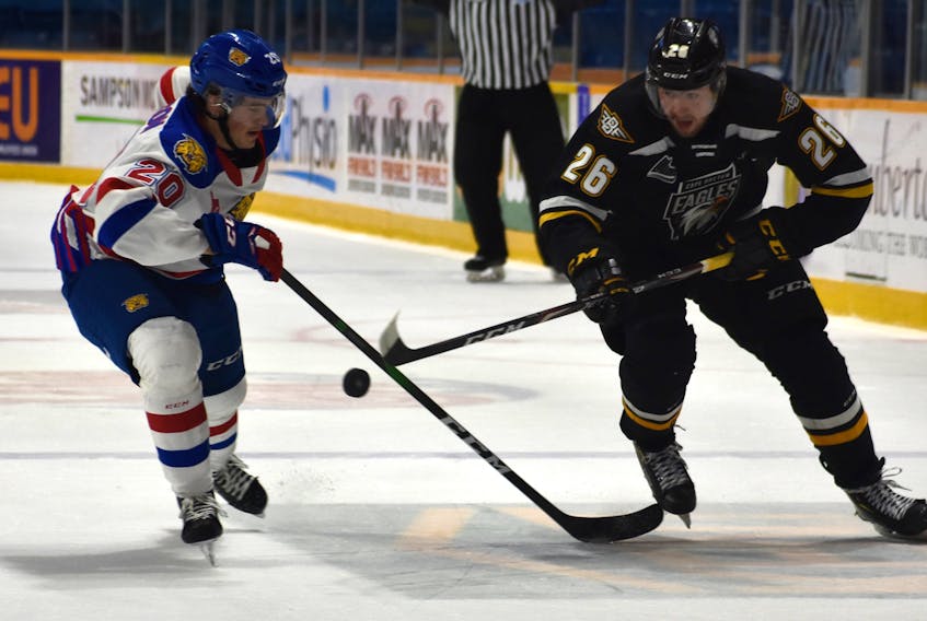 Cape Breton Eagles forward Egor Sokolov, right, and Moncton Wildcats defenceman Axel Andersson battle for the puck during a QMJHL game at Sydney's Centre 200. (JEREMY FRASER/Cape Breton Post)
