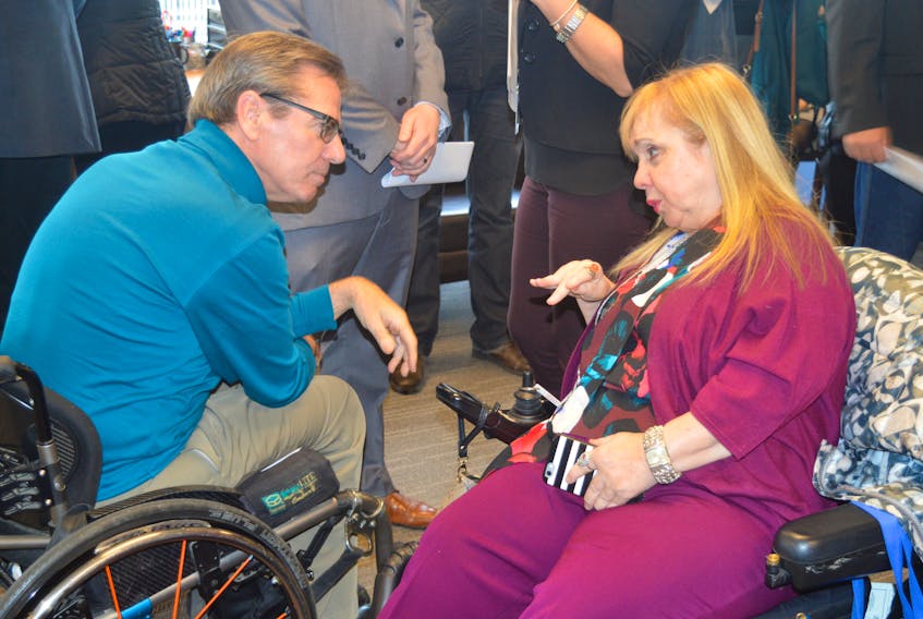 Local accessibility advocate Marcie Shwery-Stanley speaks with Gerry Post, executive director of the Accessibility Directorate, following an announcement in Sydney Friday of a new $1-million provincial program that will assist businesses that want to make changes to improve their accessibility. CAPE BRETON POST PHOTO