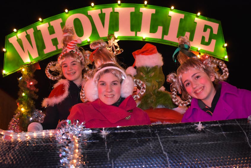 From left, Emily Neville, Jenna Gillis, and Danielle MacNeil pose for a picture with the Christmas Grinch on the Whoville float put together by Meco Construction Disaster Kleenup for the 2017 Glace Bay Christmas Parade on Friday. CHRISTIAN ROACH/CAPE BRETON POST
