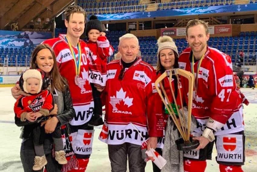 Judique native Andrew MacDonald, right, is shown posing with the Spengler Cup. Team Canada, a collection of mostly now European-based professional players, captured its record 16th Spengler Cup on New Year’s Eve in Davos, Switzerland after defeating the Czech Republic’s HC Ocelari Trinec 4-0 in the championship game. The other player in the photograph is Alex Grant of Antigonish. MacDonald presently plays for Swiss team SC Bern, while Grant is skating with Jokerit in Finland. The family members in the photo are not identified.