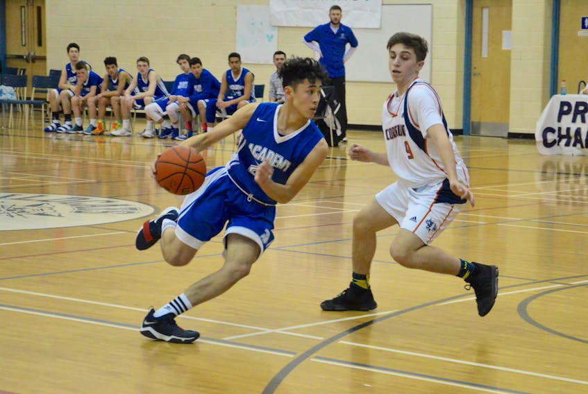 Nin Polatoglu, left, of the Sydney Academy Wildcats pushes the ball as Matt Jones of the CEC Cougars defends during NSSAF Division 1 boys provincials on Friday at Sydney Academy gym. Sydney Academy won, 100-50.