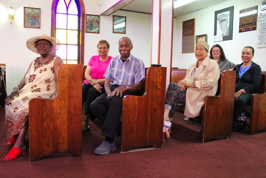 Some of the members of the congregation and a supporter of St. Philip’s African Orthodox Church in Whitney Pier, sit inside the pews of the church on July 17. From left, Monica Broomes, 75, Iris Crawford, 77, Deacon Whitfield Best, 83, Rev. Mother Phyllis March, 70, (back) Whitney MacEachern, 39, and Yvonne Stephenson, 74.