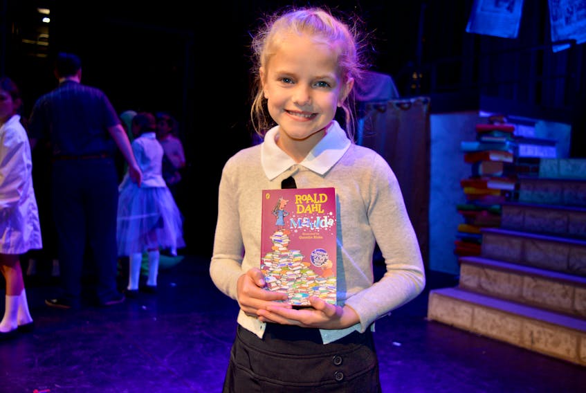 Molly Gouthro, who stars as Matilda in "Matilda The Musical" shows the book that is the basis of the production during a rehearsal in Glace Bay on Tuesday.