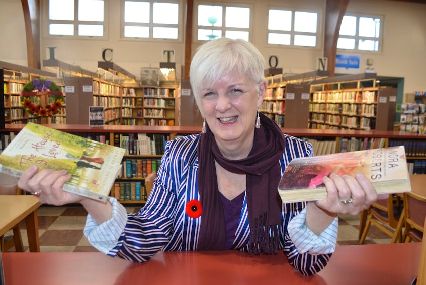 Rosalie Gillis, co-ordinator for community support for the Cape Breton Regional Library, relaxes inside the library in Sydney. Gillis said their lost books have turned up in many unusual places, including at a book sale in Mexico.