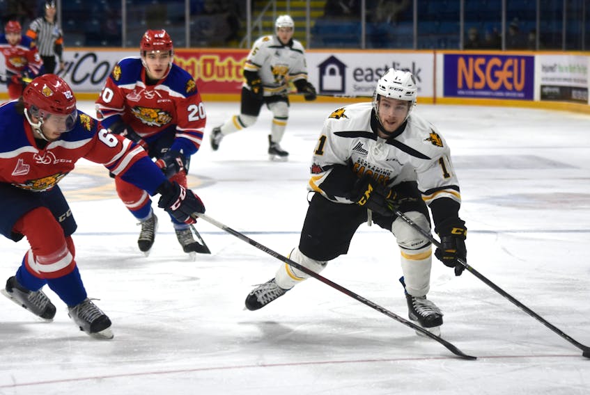 Tyler Hylland of the Cape Breton Screaming Eagles, right, heads to the goal while being watched by Daniil Miromanov of the Moncton Wildcats during the first period of Quebec Major Junior Hockey League action Wednesday at Centre 200. Hylland scored the eventual winner in Cape Breton’s 8-2 win. T.J. Colello/Cape Breton Post