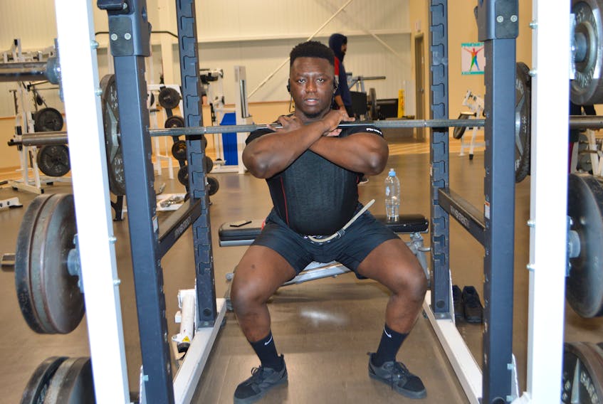 Michael Alagbe, originally from Nigeria and now living Sydney, works out on the squat rack at the YMCA of Cape Breton gym. Alagbe, a recent graduate of Cape Breton University, said the exercise makes him feel good and happy and is how he enjoys starting out his days. Officials at some gyms say although January always brings a spike in memberships as people set healthy goals for the new year, the spike began early this year, in December.