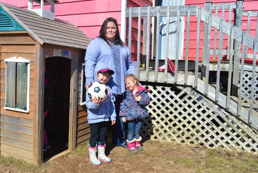 Deanna Nearing, centre, stands outside her Explore and Discover Early Childhood Learning Centre in Sydney with four-year-old Emma Mugford on her left and three-year-old Jillian Piercey on her right. As the pre-primary program rollout continues, Nearing, who has two child-care centres in the Cape Breton Regional Municipality, worries about the future of her business and the child-care industry in Nova Scotia.
