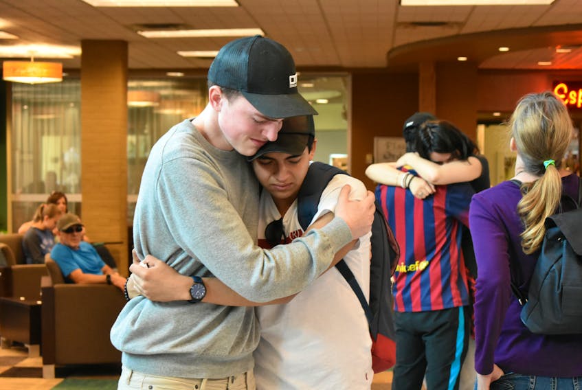 It was an emotional goodbye for friends Kyle Hickey, left, and Martin Pilataxi-Barrera on Monday. The two became close thanks to Hickey’s family hosting Pilataxi-Barrera while he was in Sydney as part of the Nova Scotia International Student Program.