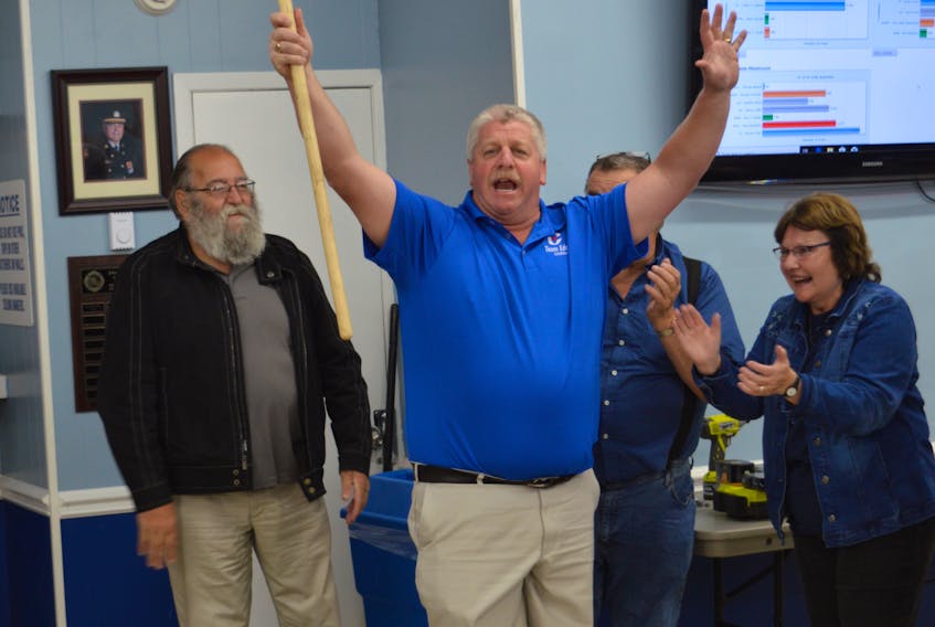 Former Progressive Conservative MLA Eddie Orrell waves a broom to represent the Tory sweep in three Nova Scotia byelections on Tuesday: Sydney River-Mira-Louisbourg, Northside-Westmount and Argyle-Barrington.