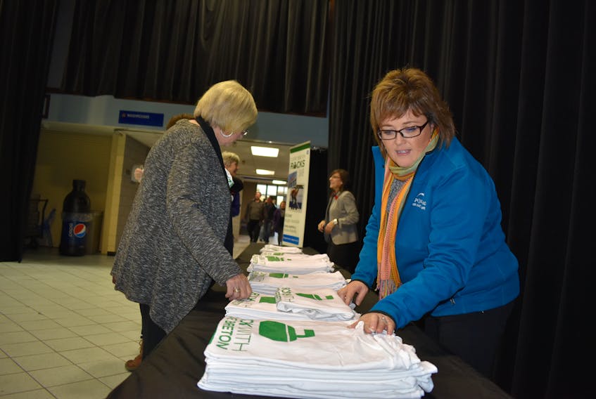 People snapped up Cape Breton Rocks T-shirts handed out by Deb McPherson from Destination Cape Breton, right. GEG MCNEIL/CAPE BRETON POST