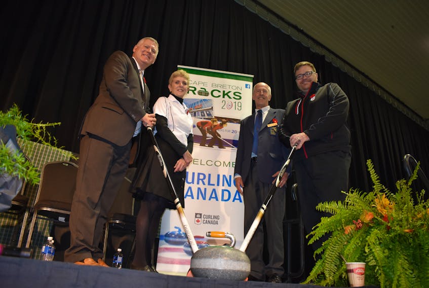 From left, CBRM Mayor Cecil Clarke, Virginia Jackson, a former provincial curling champion, Harry Daemon, president of the Nova Scotia Curling Association, and Al Cameron, director of communications and media relations for Curling Canada. GEG MCNEIL/CAPE BRETON POST