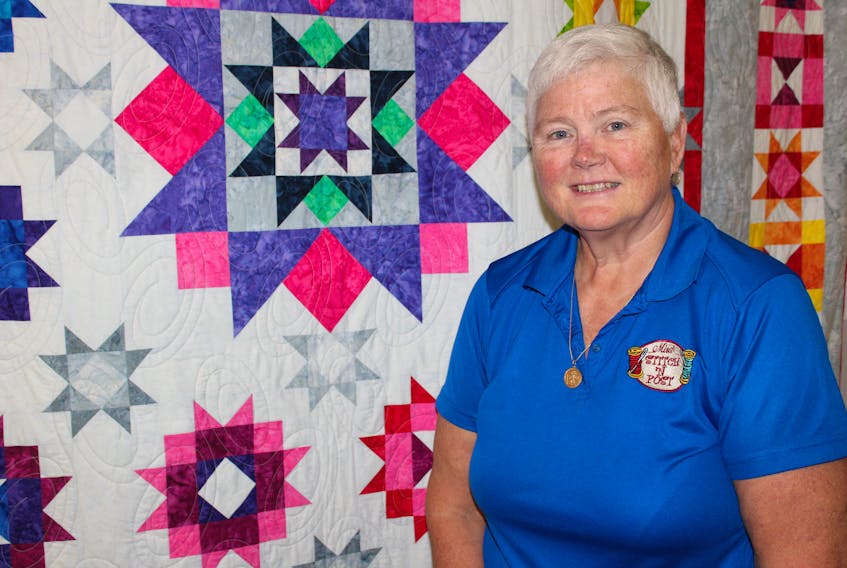 Jacquie Gillis, owner of the Mira Stitch ‘n Post in Marion Bridge, is shown in her shop with one of the colourful quilts on display. Gillis has been in business at the location for 12 years and was recently named one of the top sellers of sewing machines in North America for SVP Worldwide.