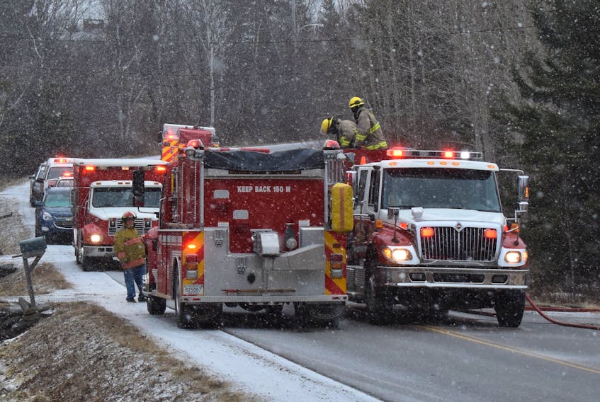 In this file photo from March, firefighters from the Scotchtown and New Waterford volunteer departments are shown at a structure fire in River Ryan. The Cape Breton Regional Municipality is now looking to repair a communication breakdown with fire chiefs of local volunteer departments.