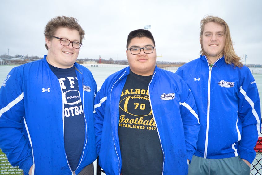 From left, Daniel Petrie of Sydney, Liam Gould of Eskasoni and Bryce MacCormack of Sydney, graduates of the Sydney Academy Wildcats football team, will move on to university football in the fall. Petrie and MacCormack will attend St. Francis Xavier University, while Gould will head to Dalhousie University.