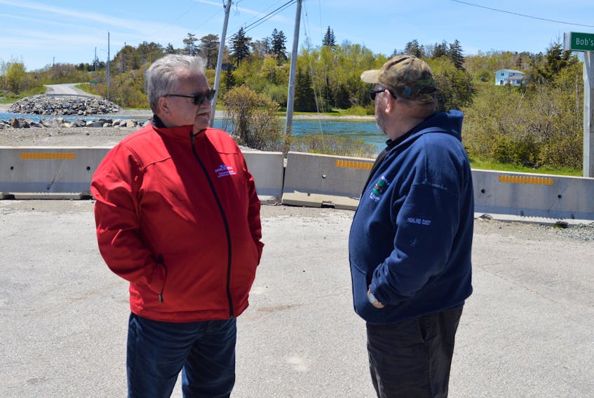 Nova Scotia Transportation and Infrastructure Renewal Minister Lloyd Hines speaks with Hornes Road resident and Isle Royale ATV Club representative Jim Surette during a tour of rural roads in eastern Cape Breton on Monday. The Minister acknowledged that many of the area’s secondary highways are in poor shape and will be addressed, but he stopped short of making any specific promises in terms how much provincial money will be spent on road upgrades.