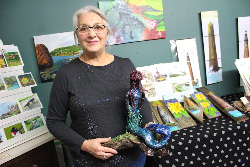 Agnes O'Flaherty is surrounded by her artwork while standing inside her Sydney Mines home studio. The Newfoundland native says she draws heavily on the ocean for inspiration and uses beach finds in many of her creations.