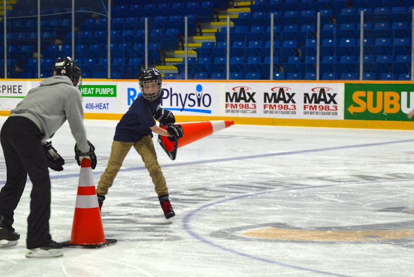 Twelve-year-old Jeremy Morneau, right, fools around with his friend Brooklyn Knowles, 14, during Etolie de l'Acadie's school skating at Centre 200 on Wednesday.