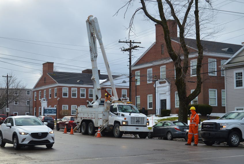 A Nova Scotia Power crew battles high winds and tree branches as it tries to make repairs along George Street in Sydney on Friday. An exploded transformer was spotted in the area. There were no reported power losses Friday morning in this part of the city, but sporadic outages were reported in other areas.