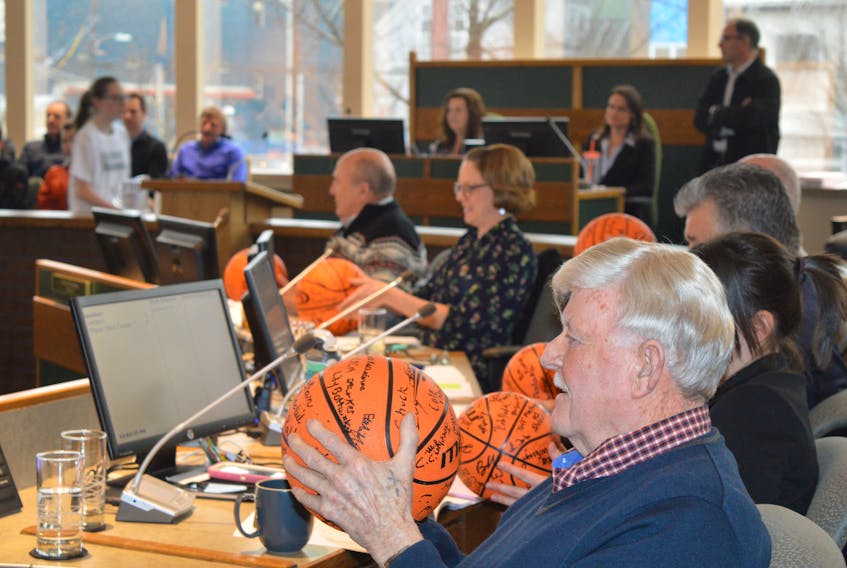 Members of the Cape Breton Regional Municipality’s council received autographed basketballs from members of Basketball Cape Breton during a stakeholder consultation session held Monday in Sydney, including District 12 Coun. Jim MacLeod, in the foreground.