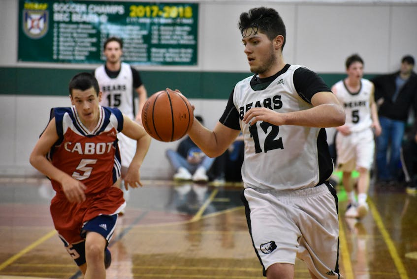Dylan Messervey (right) led the Breton Education Centre Bears with a game-high 25 points in a 99-71 win over the Cabot Trailblazers on Monday at the annual New Waterford Coal Bowl Classic at BEC gym in New Waterford. In hot pursuit is Cabot’s MacKenzie Leblanc.