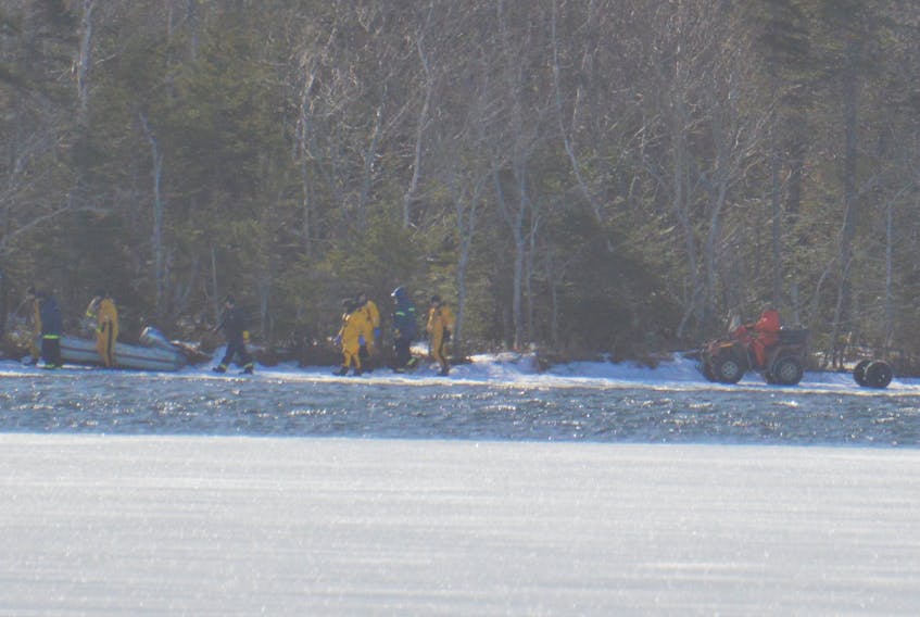 Some emergency response officials are seen on the far side of Waterford Lake during the search for Debbie Lee Pearson, 48, of New Victoria who died after she went through the ice while cross-country skiing on Saturday. Pearson’s body was recovered at about 10:40 a.m. Monday.