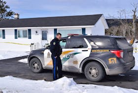 Const. Brett Bursey of the Cape Breton Regional Police Service is shown on the scene at 2278 Kings Road in Howie Centre Friday afternoon, where a 71-year-old woman was found dead Friday morning and a 73-year-old man was taken into custody. Police say they were called to the Howie Centre residence at 8 a.m. regarding a domestic incident.