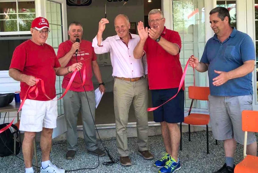 From left, Owen Marsh (first mate), Donald Jessome (commodore), Sydney-Victoria MP Mark Eyking, CBRM Mayor Cecil Clarke and Glenn MacPhee (second mate) are shown cutting the ribbon to the new clubhouse at the Georges River Boat Club on Sunday.