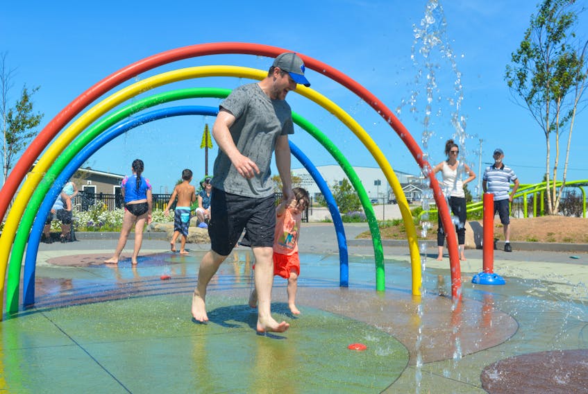 Above, Keith Gillis and his daughter Grace were among the many to seek relief from Wednesday’s heat at the splash pads at Open Hearth Park in Sydney. Activity on the pads started early in the morning and continued throughout the day as temperatures reached 30 C for many locales.