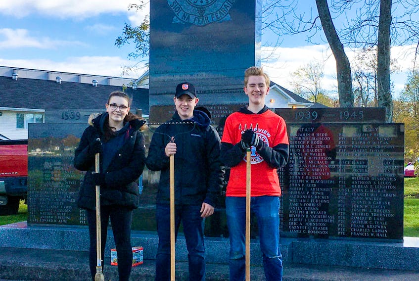 Members of the Interact Club at Riverview High School were busy removing the summer plantings and tidying up the flower beds at the Cenotaph on Kings Road. The work was in preparation for the Remembrance Day ceremony that will take place there Nov. 11. Interact Members helping were, from left, Cally Burke, Stephen Chiasson and Jack Gillespie. The Club is sponsored by the Rotary Club of Sydney. Photo by Bob Munroe