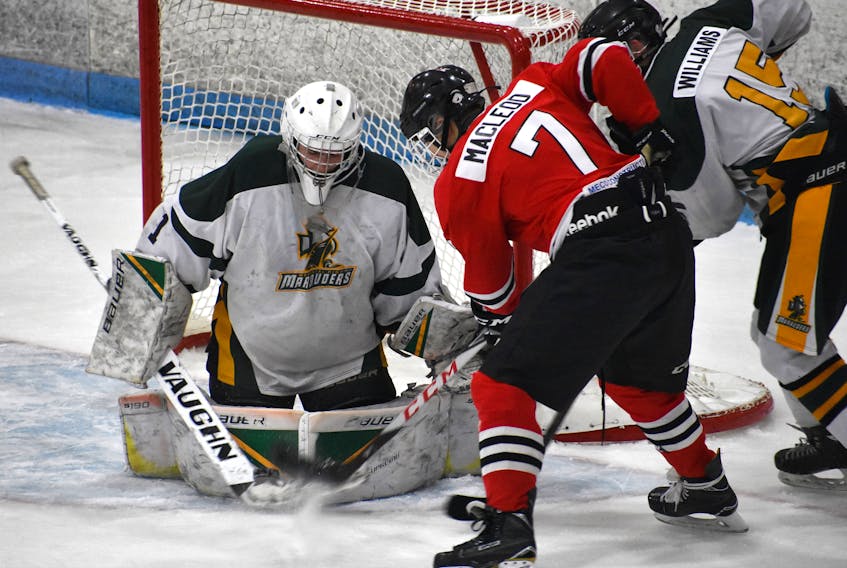 Colin MacLeod of the Glace Bay Panthers, middle, tries to put the puck past Memorial Marauders goaltender Spencer Shebib, left, while Matthew Williams of the Marauders looks to break up the play on Tuesday at the Canada Games Complex. The Panthers took Game 1 of the best-of-seven Cape Breton High School Hockey League opening-round series, 5-2.