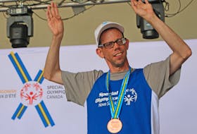 Carey Clannon of Arichat celebrates on the podium Saturday, one of the three track-and-field bronze medals he captured at the Special Olympics Canada 2018 Summer Games in Antigonish.