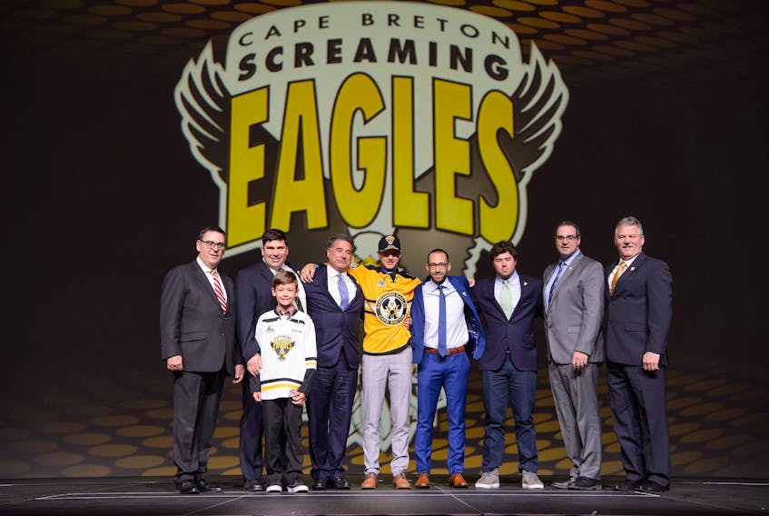 The Cape Breton Screaming Eagles selected defenceman Jérémy Langlois with the team’s first-round pick, No. 17 overall, at the Quebec Major Junior Hockey League Entry Draft at the Vidéotron Centre in Quebec City on Saturday. Members of the Screaming Eagles organization are shown with Langlois on stage following the selection. From left, Gilles Courteau (QMJHL commissioner), Jacques Carrière (Screaming Eagles general manager), Nathan Chenier (son of scout Dominic Chenier), Irwin Simon (Screaming Eagles majority owner), Langlois, Patrick Leblond (Quebec head scout), Trevor Simon (son of Irwin Simon), Jonathan Murphy (Atlantic Canada head scout) and Gerard Shaw (Screaming Eagles governor and president). Photo/Vincent Éthier, QMJHL