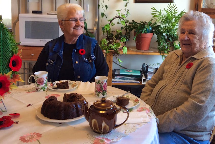 Georgina Keeping and Alena Giovannetti have a cup of tea and war cake while reminiscing about the hardships faced by many people during the war years. Giovannetti joined the Royal Canadian Air Force when she was 19 years old. This 95-year-old veteran remembers the rationing of food and having to rely on ration booklets and food stamps. She commented that many items considered staples in today’s kitchens were rare and greatly appreciated during the war. Giovannetti attends the Nov. 11 ceremony in Port Morien every year.
