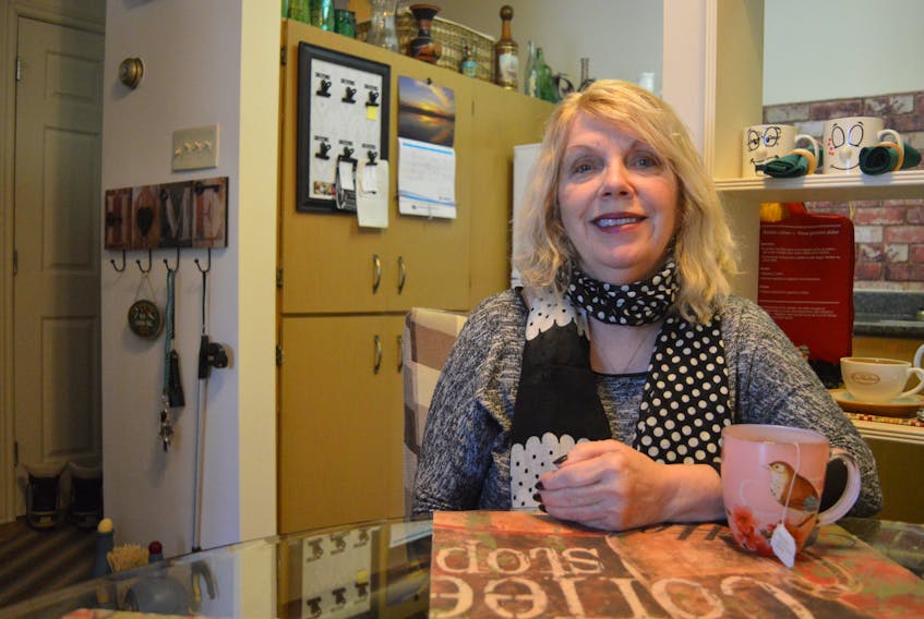 Flora Crocker sits at the kitchen table in her apartment in Sydney. Since being injured on the job in 2007, Crocker has been unable to work and suffers from chronic pain and limited movement of her left arm. The Nova Scotia Workers Compensation Board has refused her claim for wage compensation five times and she doesn’t understand why.