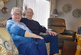 Lorraine Peddle, left, sits beside her husband Bob Peddle in the living room of their Sydney home. Lorraine is wearing a compression sleeve to help with her lymphedema, a condition sometimes caused by cancer treatments.
