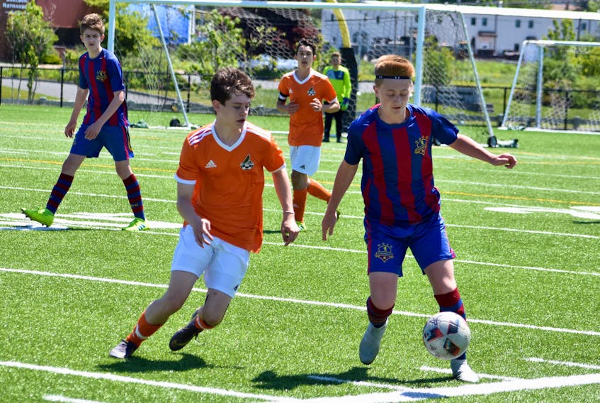 Cape Breton FC midfielder Quinn Gouthro, foreground left, closely marks Liam Chisholm of Suburban FC SFC during first-half action in a Nova Scotia Soccer League boy’s under-15 division match at Open Hearth Park Turf in Sydney on Sunday afternoon. Cape Breton won the match 3-2 after defeating the same team 4-2 the previous evening on the game pitch. The wins boost the local side’s division-leading record to 6-1-1, 19 points. Suburban FC fell to 3-3-1 on the summer season.