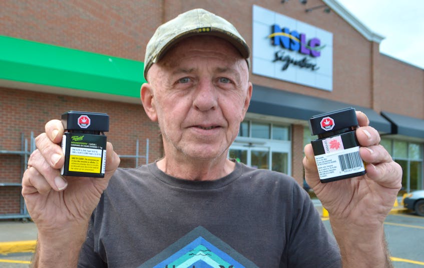 George Poulain, 67, of Point Edward, holds two containers of cannabis products outside the Nova Scotia Liquor Corporation’s Sydney River store. Poulain said on Friday he was in the process of paying for two identical products when the employee shook the containers leading to discover one contained nuts and bolts and not marijuana. Poulain said the container in question still had the government seal so whatever happened to the product had to have happened at the plant, Canopy Growth Corporation of Smith Falls, Ont.