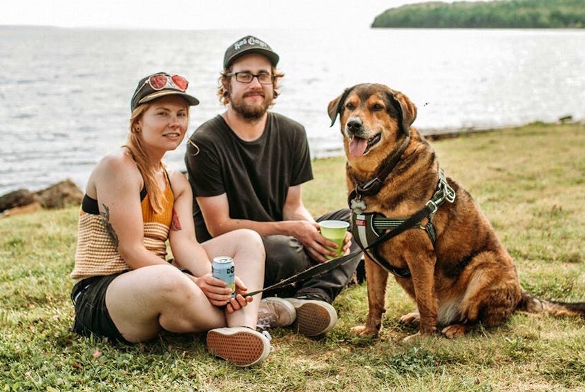 Alysha Jessome, from left, her partner Shane Wilkie and their dog Randy. Jessome has organized a community walk along the Baille Ard Trail on Saturday at noon. The CBRM’s preliminary plans, which have already been approved by council, could see eight large embankments — each eight feet high, 50 feet wide and between 300 and 400 metres long — cutting across large sections of the 70-acre forest and four-kilometre trail system.