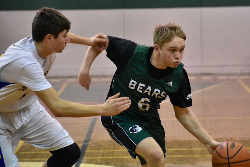 Kerry Arcon of the Shelburne Rebels, left, guards Tony Tighe of the Breton Education Centre Bears during action at the annual New Waterford Coal Bowl Classic on Thursday at BEC gym. Tighe was named his team’s player of the game in a 79-66 win.