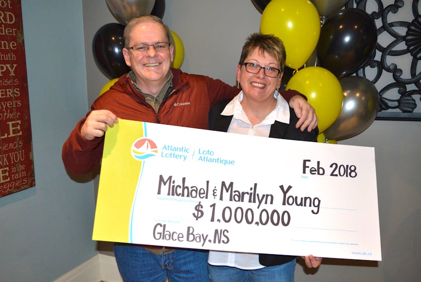 Michael Young and his wife Marilyn pose with their ceremonial  $1 million cheque during an Atlantic Lottery celebration at Talo Cafébar in Glace Bay on Thursday. That was the top prize in an X Money scratch ticket Michael had purchased at Jack’s Place on Union Street in Glace Bay about two weeks ago. When asked how the huge win will change their lives the couple said, “It won’t.”