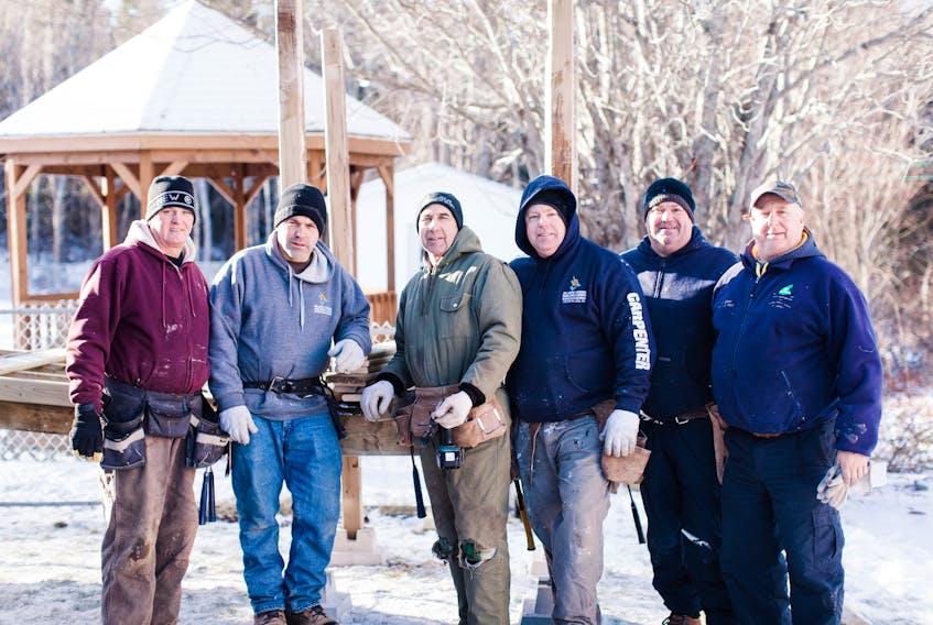 These men took time away from their families during their Christmas vacations to help build a wheelchair ramp for a woman in need. Her family is overwhelmed by the kindness of the act, even though the woman died before being able to use it. From left, Allan MacDonald, Brad Webber, Ernie Mugridge, Joe Wilson, Gordie Jacob and Lorne Carabin.
