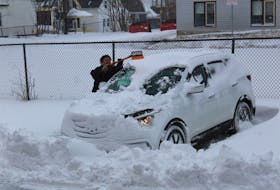 Like the majority of Atlantic Canadians on Monday, Sydney resident Terri Walker had to uncover her vehicle from under a pile of snow after a storm blanketed the region. The storm shut down the majority of businesses and services as high winds made visibility near zero.