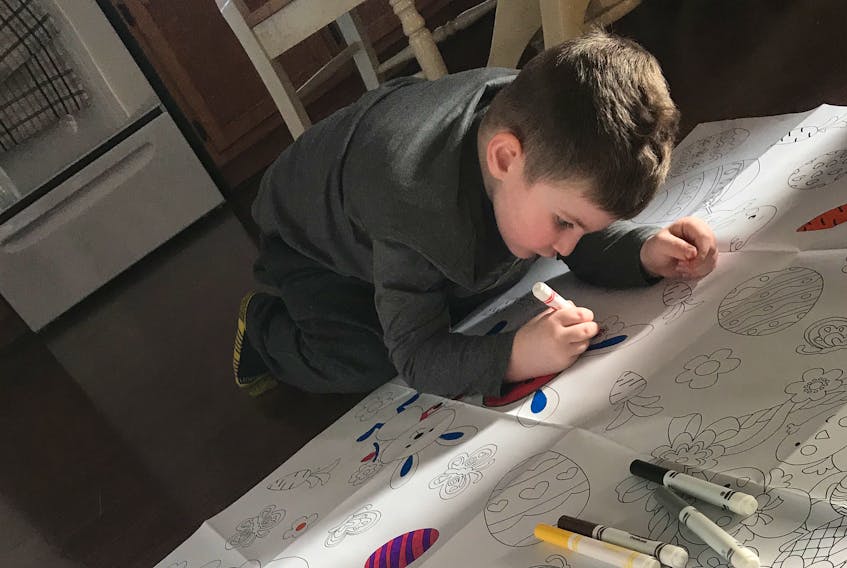 Four-year-old Aaiden Gallant works on his Easter colouring while staying at his Sydney home with his mother, Marissa, during the emergency measures enacted by the provincial government to combat the COVID-19 outbreak.
