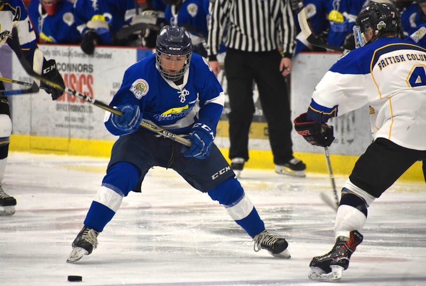 Membertou’s Sonny Kabatay of Team Atlantic, left, breaks in on Jayce Schweizer of Team British Columbia during their game at the 2018 National Aboriginal Hockey Championships on Tuesday at the Membertou Sport and Wellness Centre. British Columbia skated to a 4-2 win.