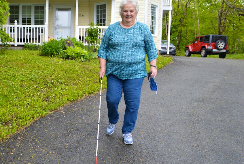 Louise Gillis of Sydney, president of the Canadian Council of the Blind, goes for a walk near her home. Gillis said regulations and policies in conjunction with the COVID-19 crisis need to include people with disabilities.
